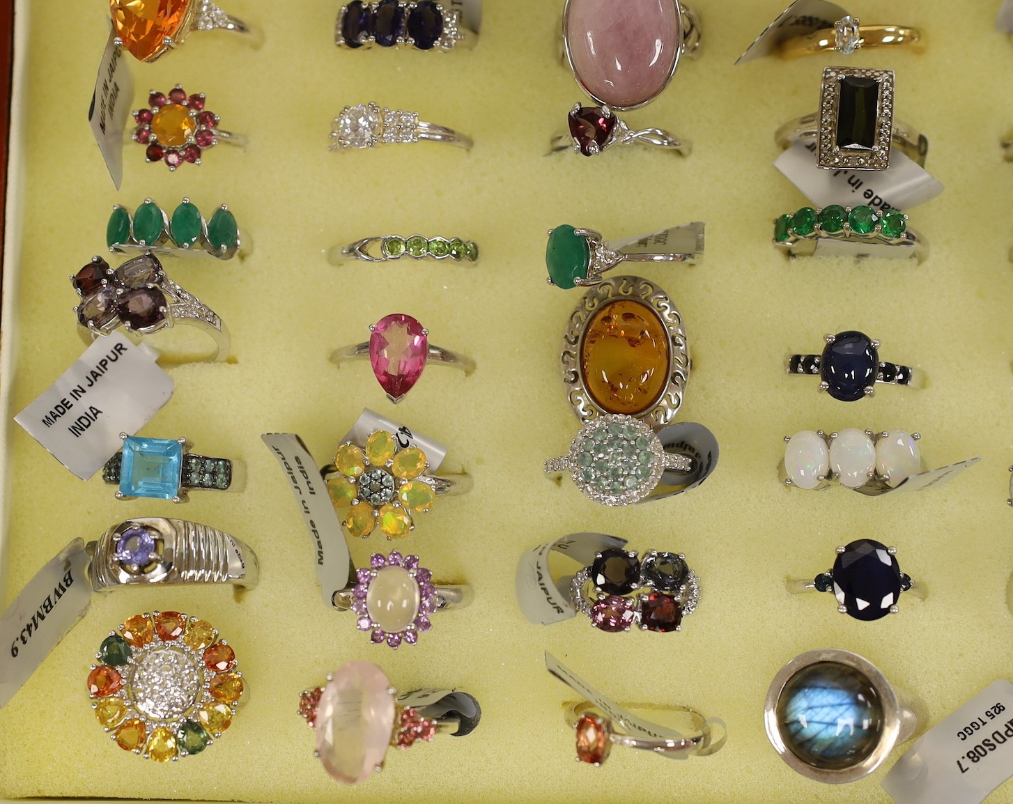 Forty seven assorted modern 925 and gem set rings and seven assorted modern 9ct gold and gem set rings, in ring box (hinges damaged).